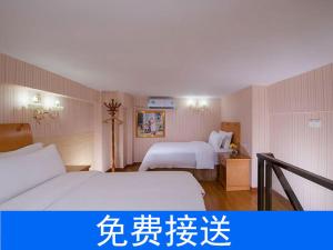 a hotel room with two beds and writing on the wall at Vienna Hotel Guangzhou South Railway Station in Guangzhou