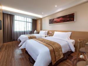 a hotel room with two large beds in it at Vienna 3 Best Hotel Shenzhen Pinghu Fumin Road in Longgang