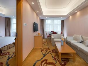 a hotel room with a couch and a living room at Vienna Hotel (Tianyang Old City High Speed Railway Station) in Baise