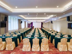 a large room with rows of tables and chairs at Vienna Hotel Shenzhen Longzhu in Shenzhen