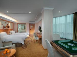 a hotel room with two beds and a pool table at Vienna Classic hotel(Lianzhou Building Branch) in Lianzhou