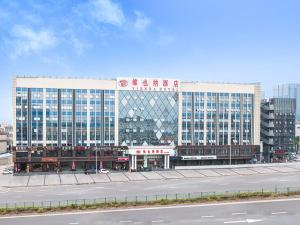 a large office building with a road in front of it at Vienna Hotel Shenzhen Pingji Ave in Longgang