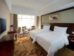 Voodi või voodid majutusasutuse Vienna Hotel Heyuan Hongxing Road toas
