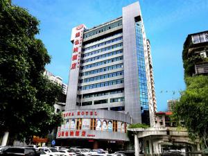 a tall building with cars parked in front of it at Vienna Hotel Changsha Mid Furong Road in Changsha