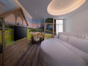 a bedroom with a large bed and a tv in it at Vienna International Hotel(Jinjiang Jordan Center) in Jinjiang