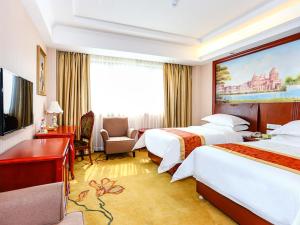 Postel nebo postele na pokoji v ubytování Vienna International Hotel Shanghai Fengxian Nanqiao + 12 fotografií