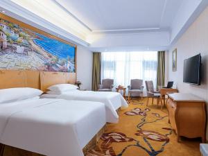 a hotel room with three beds and a television at Vienna Hotel(Anqing Guangcai Seven-street) in Anqing +10 photos