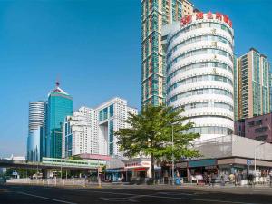 a city with tall buildings and a street in front at Vienna Hotel Shenzhen Lo Wu Control Point in Shenzhen
