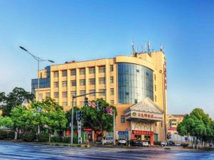 a large building on a street in front of a building at Vienna Hotel Wuxi Wangzhuang Road in Wuxi