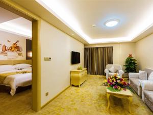 une chambre d'hôtel avec un lit et un canapé dans l'établissement Vienna International Hotel Guangdong Zhengjiang Renming Avenue Middle Road, à Zhanjiang