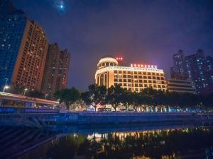 un gran edificio en una ciudad por la noche en Venus royal hotel(Keyuan Guancheng Dongguan), en Dongguan