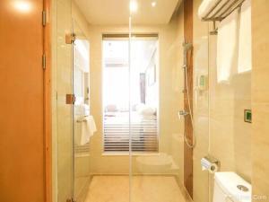 a bathroom with a shower with a glass door at Vienna Hotel Tianbao Road in Shenzhen