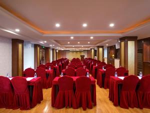 a conference room with red tables and chairs in it at Vienna Hotel Zhongshan Central Coach Station in Changzhou
