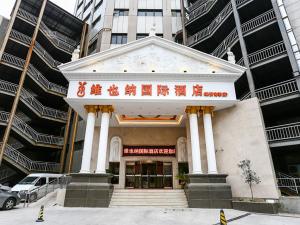 a building with columns in the middle of a city at Vienna International Hotel Shanghai Fengxian Nanqiao in Fengxian