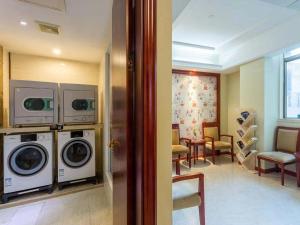 a room with two washing machines and a dining room at Vienna Hotel Foshan Jihua Road in Foshan +7 photos