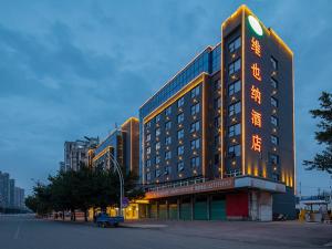 a building with an asian writing on the side of it at Vienna Hotel(Ganzhou Railway Station Shop) in Ganzhou