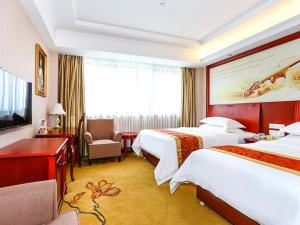 Postel nebo postele na pokoji v ubytování Vienna International Hotel Shanghai Fengxian Nanqiao