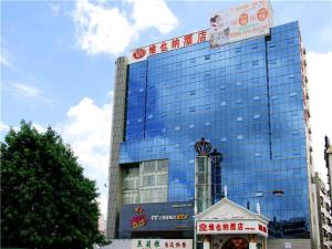 a large glass building with a sign on top of it at Vienna Hotel in Pinghu Square in Longgang