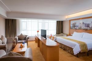 Ένα ή περισσότερα κρεβάτια σε δωμάτιο στο Vienna Hotel Dongguan Songshanhu Huawei
