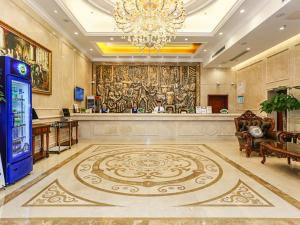 a large lobby with a large painting on the wall at Vienna International Hotel Shanghai Fengxian Nanqiao in Fengxian