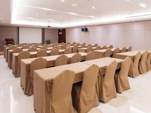 a room with rows of tables and chairs in it at Vienna Hotel Shanghai Hongqiao Airport Center in Shanghai