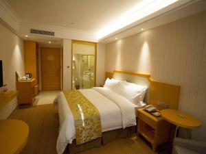 Rúm í herbergi á Vienna 3 Best Hotel Taizhou Xianju