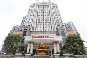 a large building with a statue in front of it at Vienna International Hotel Jieyang People's Avenue in Jieyang