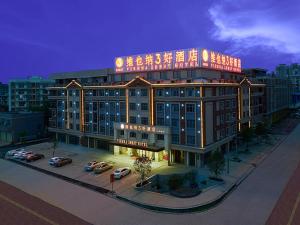 a large building with a sign on top of it at Vienna Hotel (Dongmin Road Nanning) in Nanning