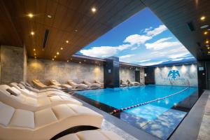 a swimming pool with chairs in a building at The Craton Hotel Sisli in Istanbul