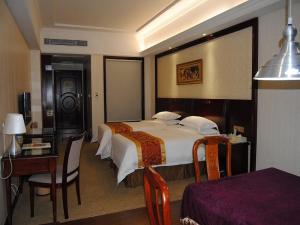Ένα ή περισσότερα κρεβάτια σε δωμάτιο στο Vienna Hotel Shanwei Lufeng Jieshi Bus Station