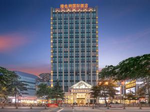 a large tall building with a lot of windows at Vienna International Hotel Jiujiang Shili Street in Jiujiang