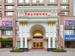 a large building with an arch in front of it at Vienna Hotel Guangdong Maoming Railway Station in Maoming