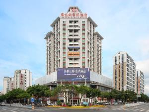 a tall building with a sign on the side of it at Vienna Classic Hotel Ganzhou Meilin in Ganzhou