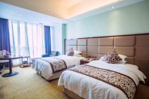 Krevet ili kreveti u jedinici u objektu Vienna International Hotel Fuzhou Cangshan Longfu