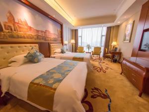Ένα ή περισσότερα κρεβάτια σε δωμάτιο στο Vienna International Hotel Guangxi Duan