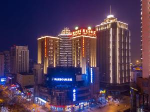 a city lit up at night with tall buildings at Vienna Hotel Shanghai Baoshan Wusong in Shanghai