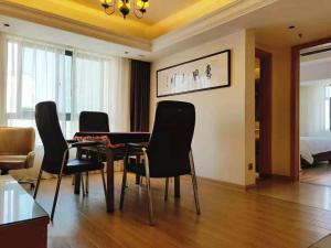 a living room with a dining room table and chairs at Vienna 3 Best Hotel (Haikou Chengmai Old Town Store) in Chengmai +3 photos