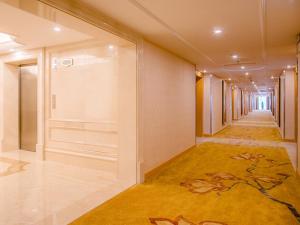 a hallway of a building with a painting on the wall at Vienna Hotel Changsha Jingwanzi Middle Mulian Road in Changsha