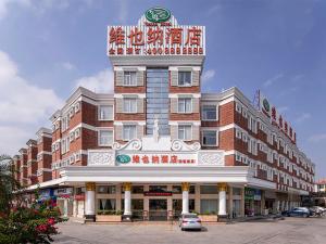 a large building with a sign on top of it at Vienna 3 Best Hotel Foshan Nanhai Film Studio City in Nanhai