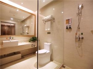 a bathroom with a shower and a toilet and a sink at Vienna International Hotel Yantai Changjiang Road Xingyi Square Branch in Yantai +12 photos