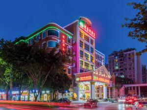 a building with neon signs on the side of it at Vienna Hotel Guilin Railway Staion in Guilin +16 photos