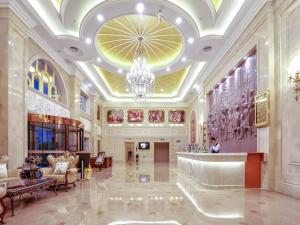 a large lobby with a chandelier in a building at Vienna Hotel Tianjin Huanghe Road in Tianjin