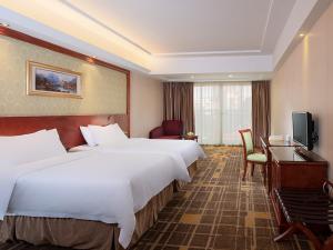 a hotel room with two beds and a desk at Vienna Hotel Dongguan Hou street Wanda Plaza in Dongguan +10 photos