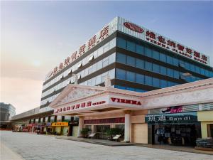 a large building with writing on the side of it at Vienna Hotel Tianbao Road in Bao'an