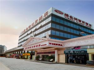 a large building with writing on the side of it at Vienna Hotel Tianbao Road in Shenzhen