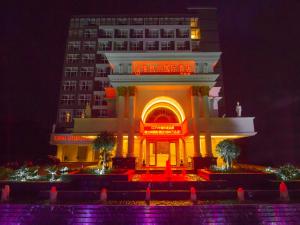 a building with a sign in front of it at night at Vienna International Hotel Guilin Wanda Plaza in Guilin