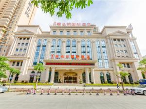 a large building with a lot of windows at Vienna International Hotel Guangdong Zhengjiang Renming Avenue Middle Road in Zhanjiang