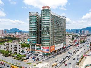 a large building with a lot of traffic in a city at Vienna Hotel Shenzhen Pingshan Shenshan Road in Longgang