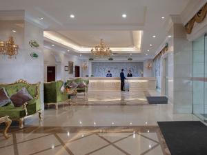 a man standing in a lobby of a building at Vienna Hotel Nanning Changhu Road in Nanning