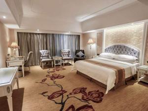 a hotel room with a large bed and a desk at Vienna International Hotel Jieyang People's Avenue in Jieyang +8 photos